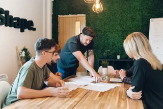 Andy giving directions during a team meeting